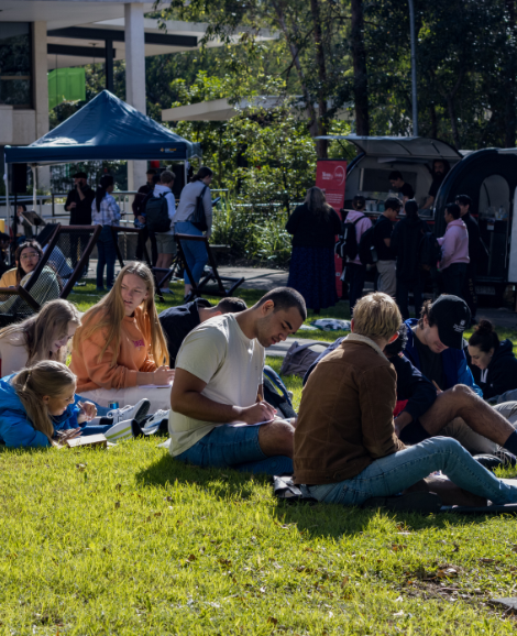 Students sitting on Goanna Lawn 