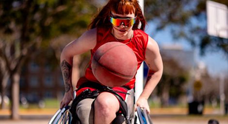 Woman in a wheelchair playing basketball