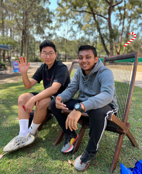 Two students sitting on lounge chairs