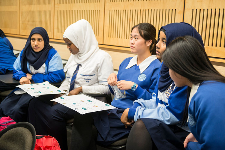 Female students listening to a lecture