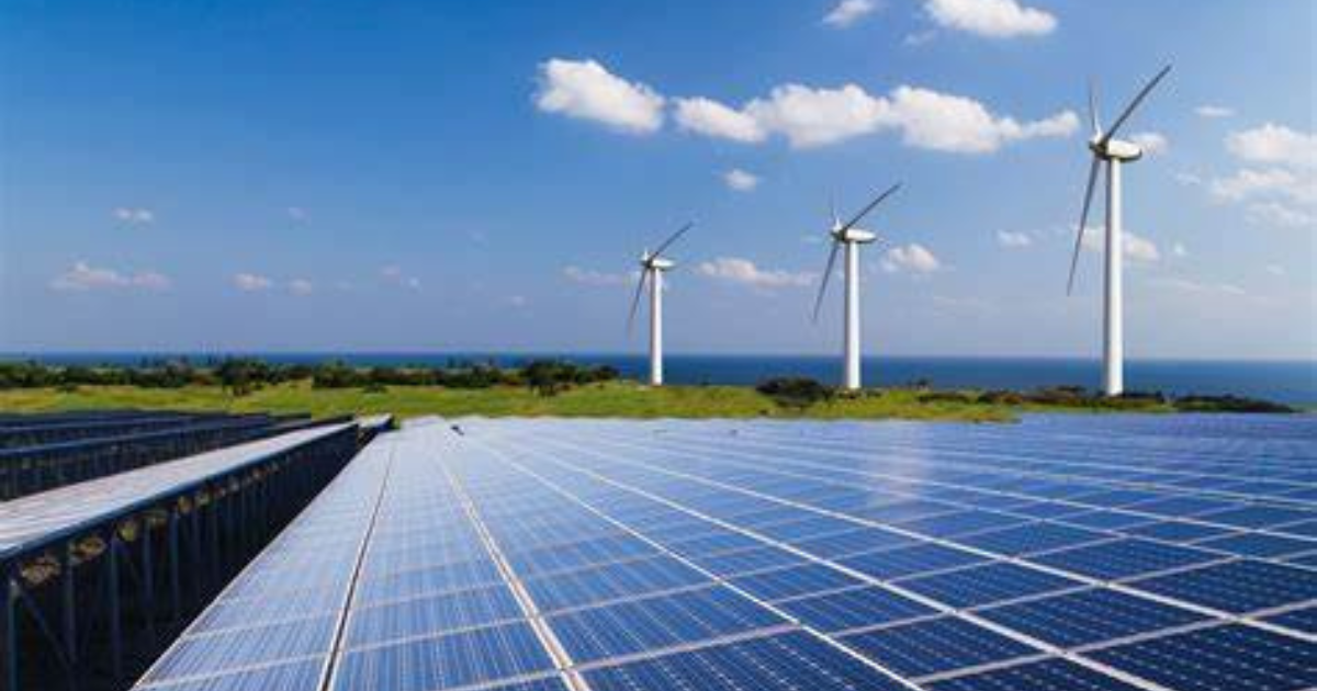 Solar pannels in a field with three wind turbines in the distance.