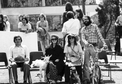 students sitting with a goat