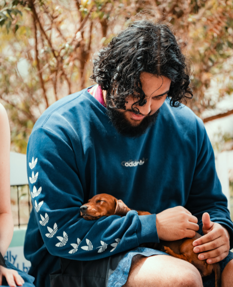 student cuddling a puppy