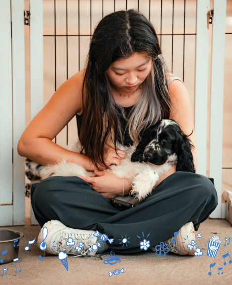 Student cuddling a puppy