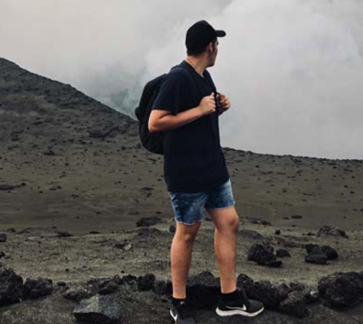 Ben Harden standing on volcano in Vanuatu