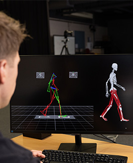 Researcher analysing biomechanical walking data on a computer screen.