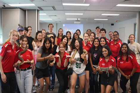 Group of students meeting Aussie reptiles including lizards, snakes, and crocodiles