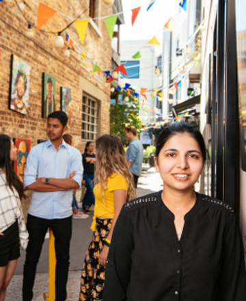 female student in a colourful decorated alley