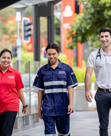 three health professionals walking outside