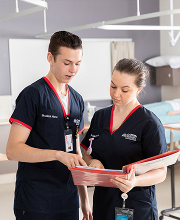 two health professionals looking at a file