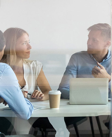 group of professionals sitting around a table