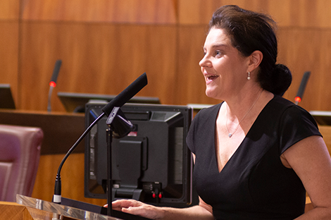 Kylie speaking at a podium