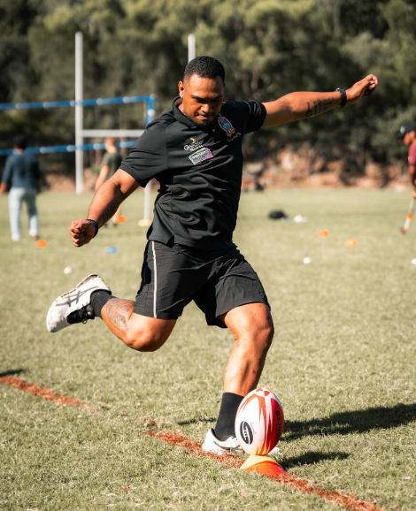 male kicking a football